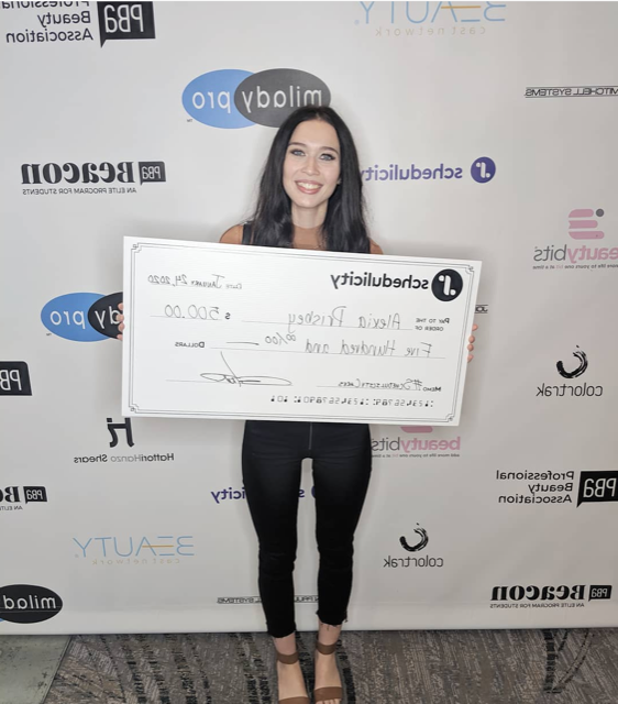 Woman holding a giant check for $500 dollars